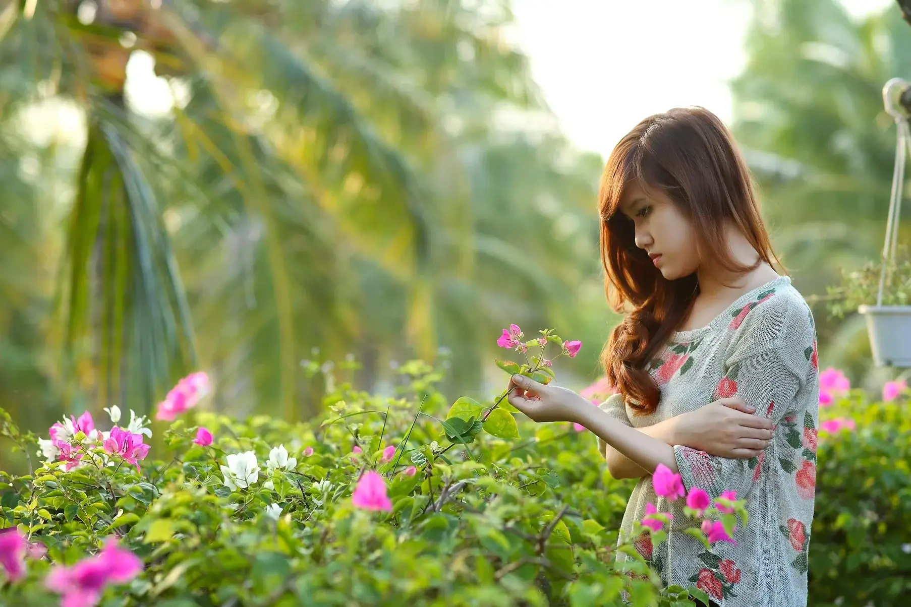 Woman tending to flowers in a garden